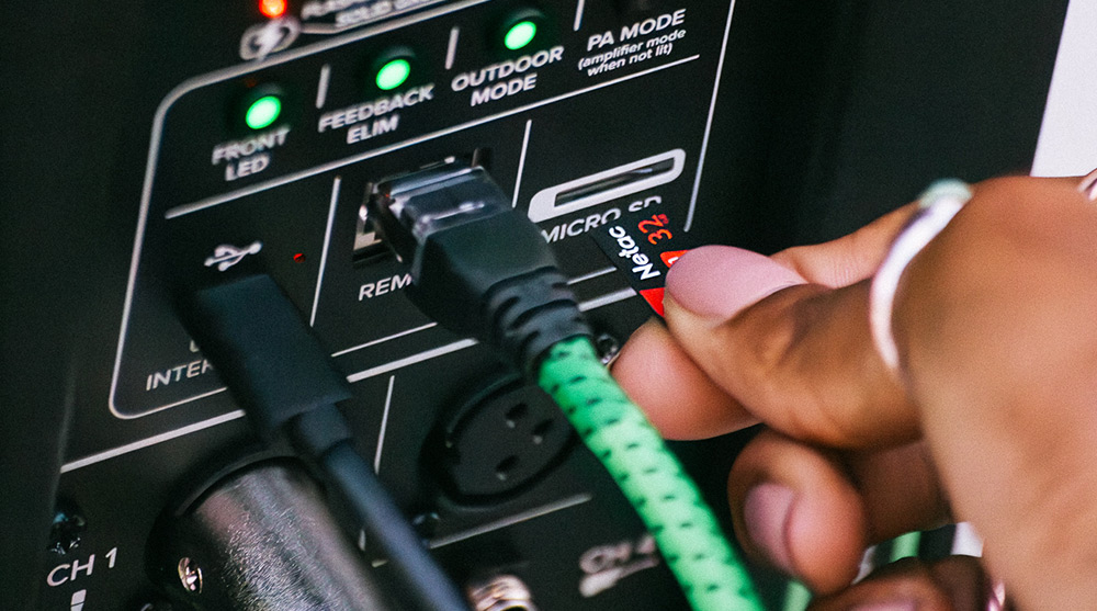 Photo of hand inserting SD card into ShowBox